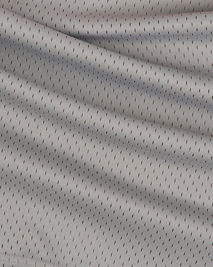 Close-up of the Ebbets Field Aloha 100th Infantry 1942 Mesh V-Neck Jersey, featuring light gray mesh fabric with small black perforations and subtle folds, inspired by Japanese-American baseball teams.