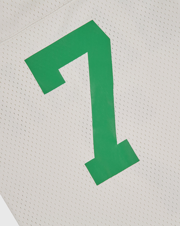 A close-up of the Ebbets Field University of Hawaii Rainbow Warriors Mesh Football Jersey features a large green number 7 on white mesh fabric.