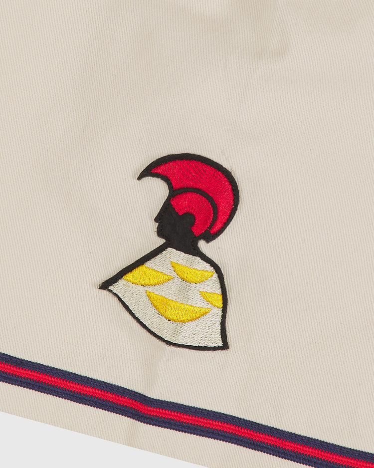 The Hawaii Islanders (PCL) 1964 Cotton Twill Baseball Jersey by Ebbets Field features a cream cotton twill jersey with an embroidered figure in profile, red helmet, white cape with yellow accents, and blue/red striped trim – inspired by classic Pacific Coast League designs.