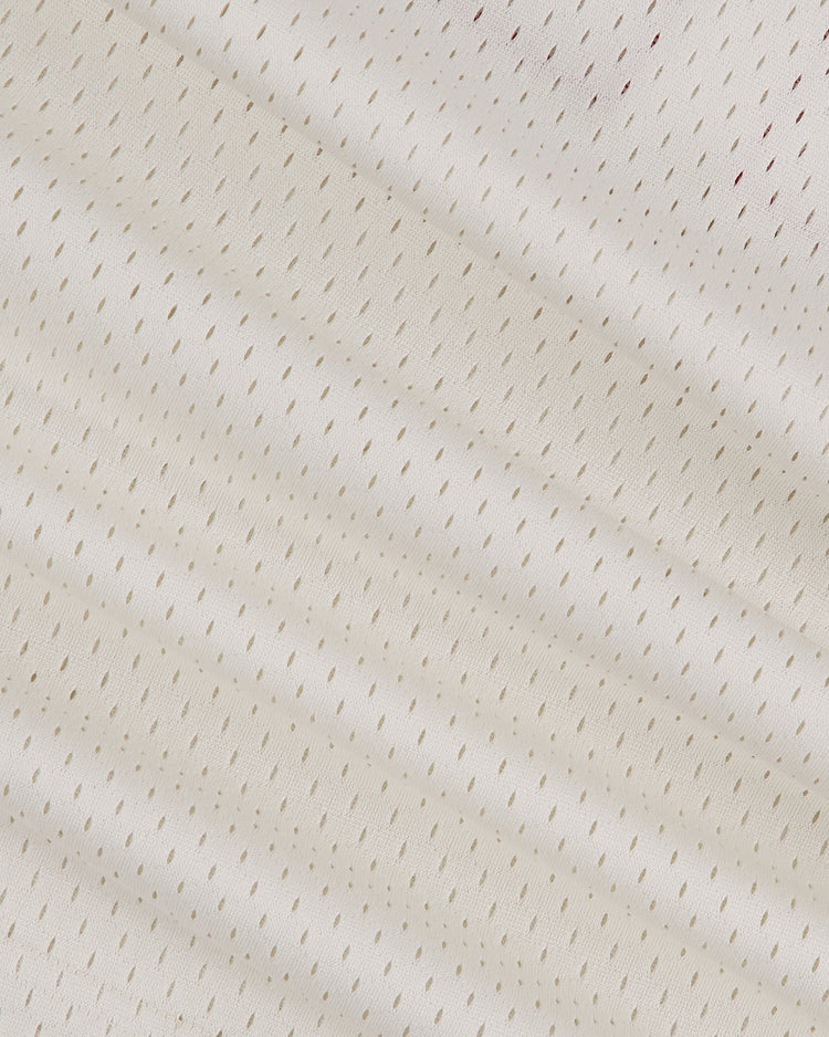 Close-up of the Ebbets Field Hawaii Islanders (PCL) 1974 Mesh V-Neck Jersey shows white mesh fabric with small, diagonal perforations for breathability and a soft, vintage-inspired texture reminiscent of classic baseball style.