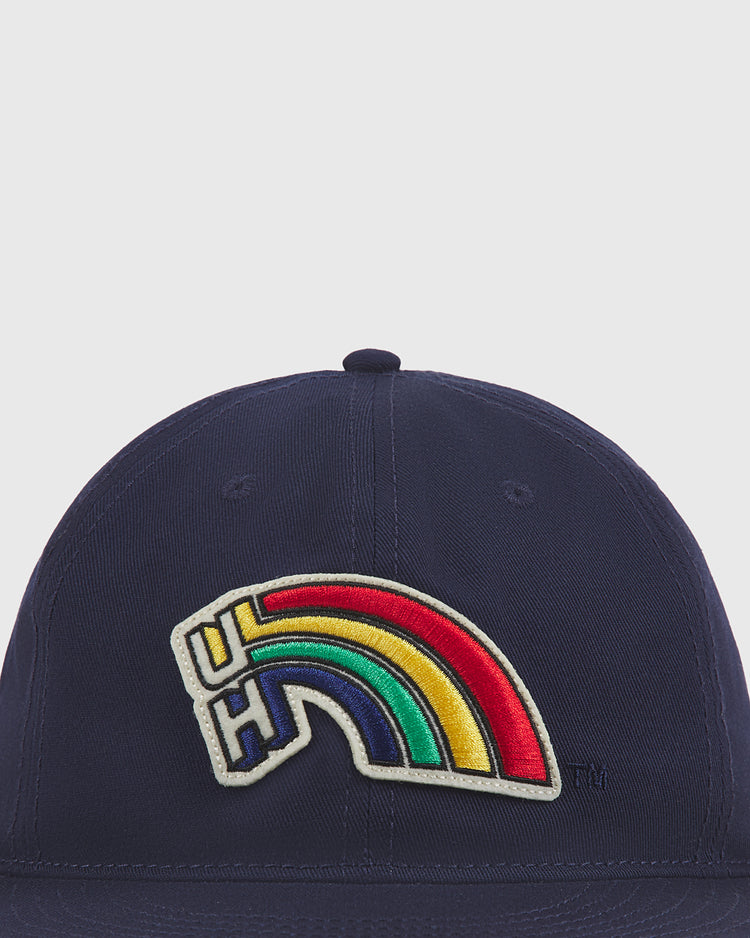 The Ebbets Field University of Hawaii Rainbow Warriors Cotton Twill Ballcap is navy blue with a colorful rainbow 