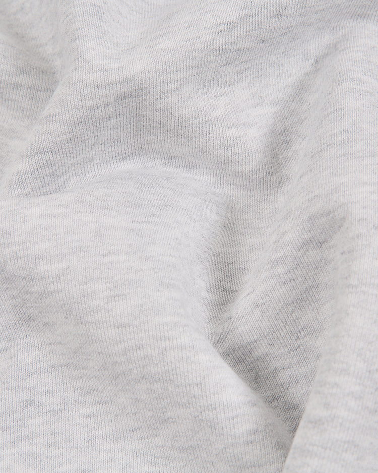 Close-up of light gray, soft-textured fabric with gentle folds and subtle shadows—ideal for the Ebbets Field New York Cubans Heavyweight Cotton Terry Pullover Flag Hoodie, inspired by classic Negro League apparel.