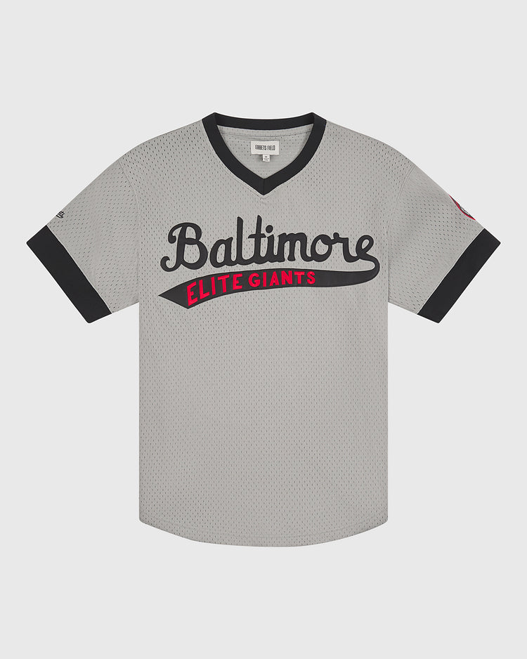 The Ebbets Field Baltimore Elite Giants 1949 V-Neck Mesh Road Jersey features a gray body with black trim, “Baltimore” in black script and “Elite Giants” in red block letters across the chest. This Negro League jersey has short sleeves and a V-neck, faithfully reproducing the style worn by the 1949 Baltimore Elite Giants.