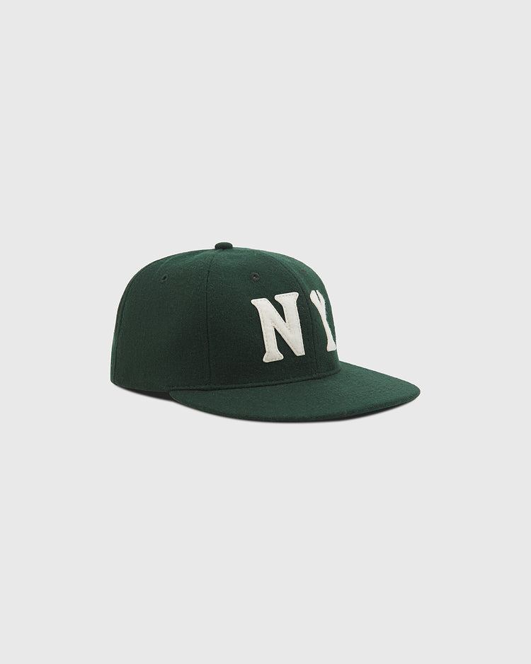 The Ebbets Field NY Black Yankees Authentic Wool Ballcap, crafted in dark green wool with white “NY” embroidery on the front and inspired by the Negro National League’s New York Black Yankees, is shown at an angle against a plain light gray background.