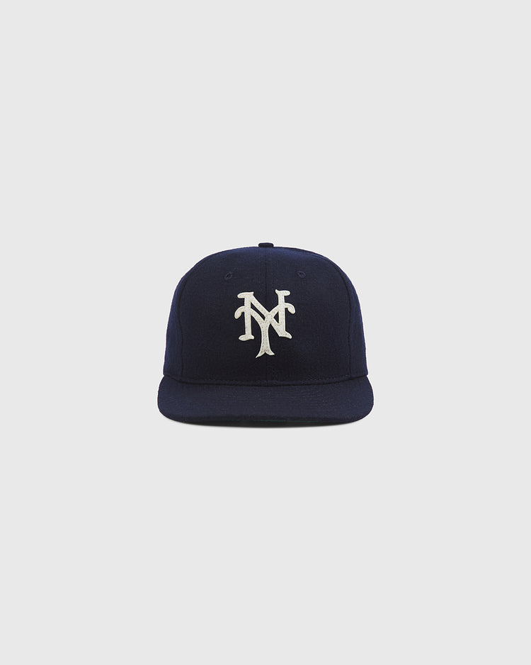 The Ebbets Field New York Cubans Authentic Wool Ballcap, featuring a navy blue wool construction and a white interlocking NY logo inspired by the styles worn by Negro National League teams like the New York Cubans, is displayed against a plain light gray background.