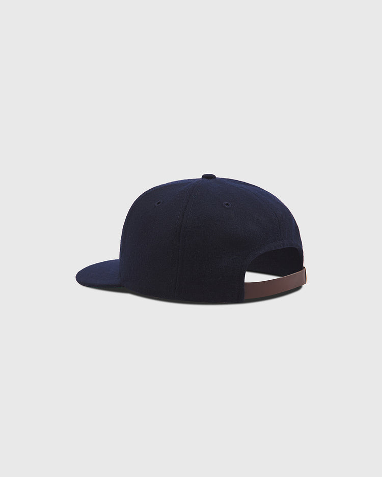 The Ebbets Field New York Cubans Authentic Wool Ballcap, shown from the back on a plain light gray background, features a navy blue wool construction, a brown adjustable strap, and a curved brim. Inspired by classic Negro National League teams like the New York Cubans, this cap blends heritage style with modern comfort.