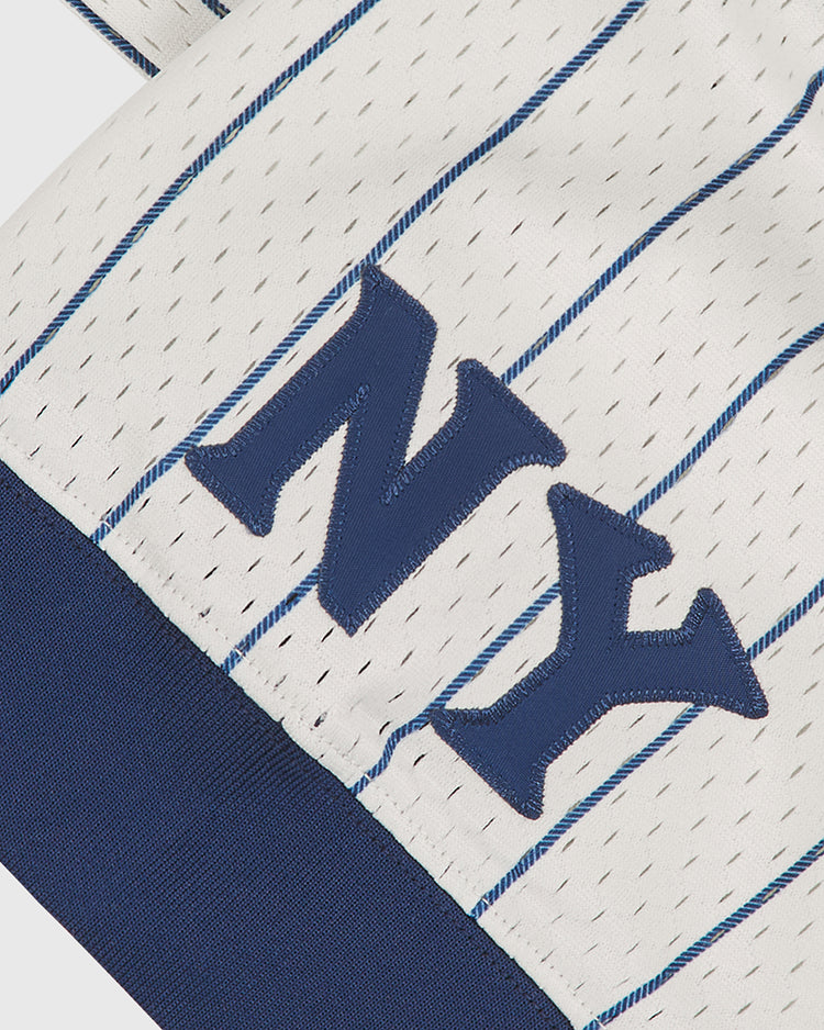 Close-up of the Ebbets Field NY Black Yankees V-Neck Mesh Jersey, featuring white pinstriped fabric with blue stitched “NY” letters and a solid blue band at the bottom, inspired by the classic jerseys worn by the Negro National League’s iconic NY Black Yankees.