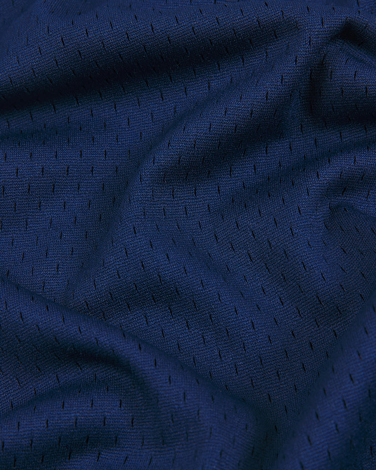 Ebbets Field NY Black Yankees V-Neck Mesh Jersey features dark blue athletic mesh fabric with small, evenly spaced holes and visible textured folds, echoing the timeless style of a classic Negro National League jersey.