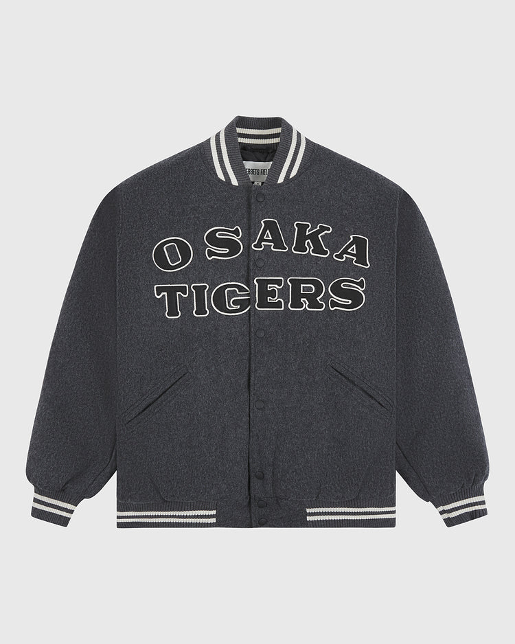 An essential piece of Japanese baseball memorabilia, the Osaka Tigers All-Wool Varsity Jacket by Ebbets Field features a dark gray design with white striped cuffs and collar, and bold white OSAKA TIGERS lettering across the front.