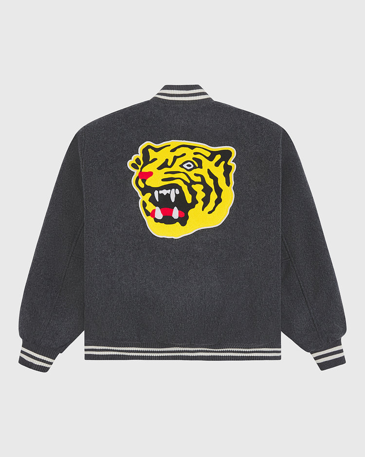 The Ebbets Field Osaka Tigers All-Wool Varsity Jacket is a dark gray varsity jacket with striped cuffs and collar, highlighted by a large yellow and black roaring tiger head graphic on the back—an ideal piece for fans of Japanese baseball memorabilia.