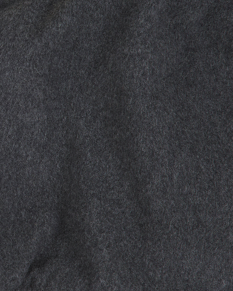 Close-up of dark gray felt fabric with a soft, fuzzy texture and subtle variations in shading, reminiscent of the premium material found in the Ebbets Field Osaka Tigers All-Wool Varsity Jacket—a prized piece among collectors of Japanese baseball memorabilia.