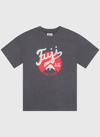 The Ebbets Field Fuji Athletic Club Pigment-Dyed Short Sleeve Graphic T-Shirt features a faded black wash and showcases a red and white front graphic with the words “Fuji A.C. Portland” alongside a mountain illustration—a tribute to Japanese American baseball history as represented by the iconic Fuji Athletic Club.
