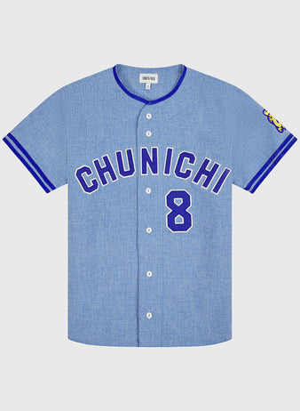 The Ebbets Field Chunichi Dragons 1969 Authentic Wool Road Jersey features a light blue vintage design with “CHUNICHI” and the number 8 boldly displayed in blue on the front, inspired by the legendary 1969 Chunichi Dragons jersey. Blue trim highlights the collar and sleeves, a colorful patch details the right sleeve, and classic white buttons run down the center, faithfully recreating all the authentic features of a true wool baseball jersey.