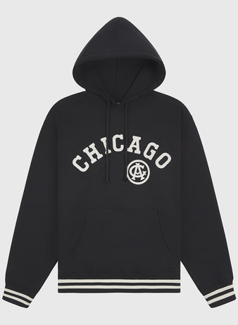 The Chicago American Giants 1927 Road Jersey Pullover Hoodie by Ebbets Field features a black design with CHICAGO and a circular AC logo, plus front pocket and black-and-white striped cuffs and hem.