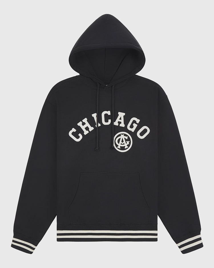 The Chicago American Giants 1927 Road Jersey Pullover Hoodie by Ebbets Field features a black design with CHICAGO and a circular AC logo, plus front pocket and black-and-white striped cuffs and hem.