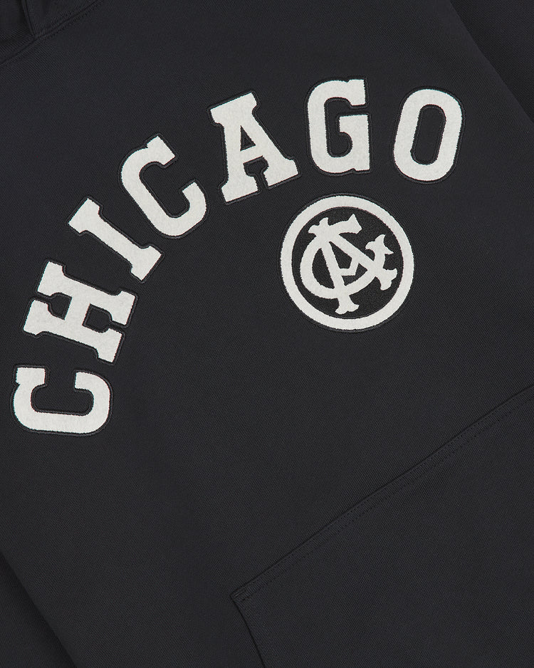 The Chicago American Giants 1927 Road Jersey Pullover Hoodie by Ebbets Field features “CHICAGO” in bold white letters and a circular logo with overlapping A and C below the text.