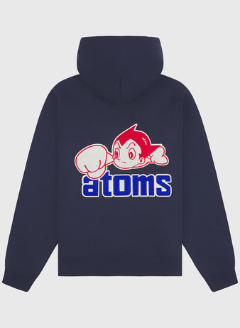 The Sankei Atoms Heavyweight Cotton Terry Full-Zip Hoodie by Ebbets Field is a navy vintage-style hoodie, featuring a graphic of a spiky-haired cartoon character with a large glove above the word “atoms” in bold blue and white lettering on the back, reminiscent of an Astro Boy sweatshirt.