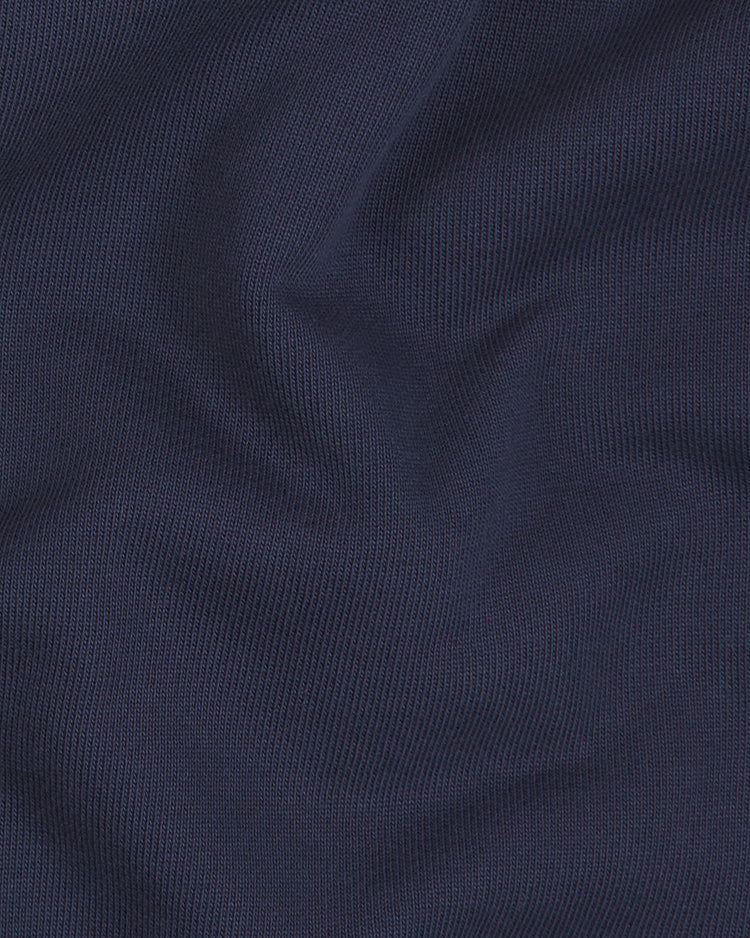 Close-up of heavyweight navy blue cotton terry fabric with fine, visible ribbed lines and gentle folds, creating soft shadows and highlights across the material—perfect for a vintage-style look on the Ebbets Field Sankei Atoms Heavyweight Cotton Terry Full-Zip Hoodie.