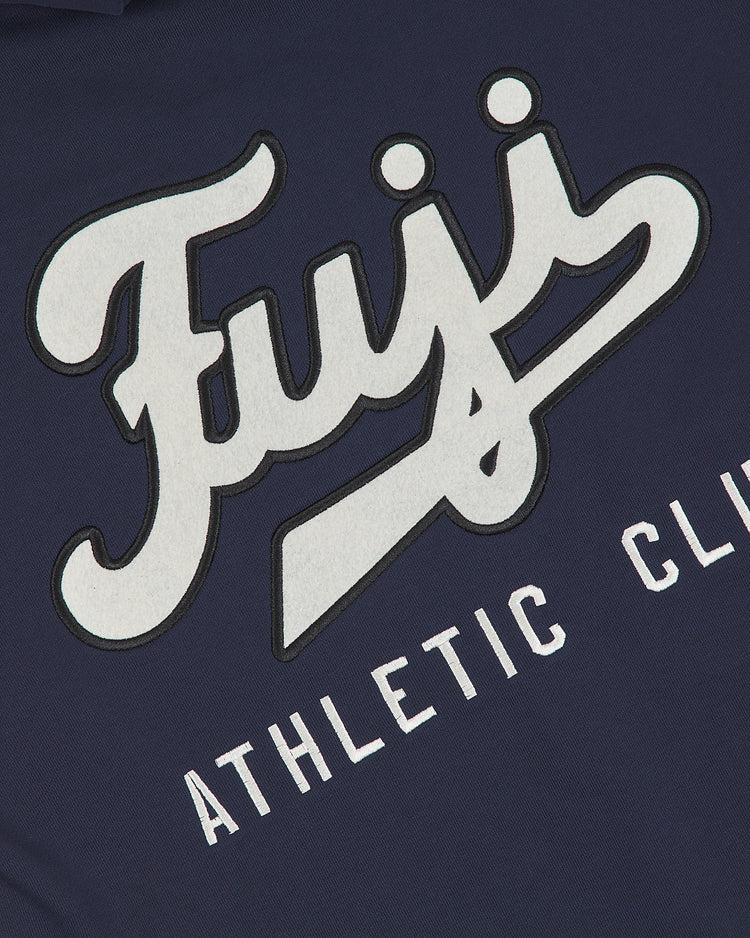 Crafted by Ebbets Field, the Fuji Athletic Club Heavyweight Cotton Terry Full-Zip Hoodie features a navy blue cotton terry fabric with bold white script reading “Fuji” and block letters spelling “ATHLETIC CLU” beneath. Inspired by Japanese American baseball, this hoodie showcases a sporty, retro design reminiscent of classic vintage athletic wear.