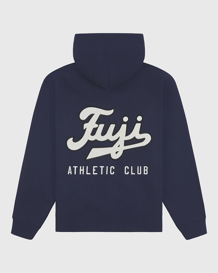 The Fuji Athletic Club Heavyweight Cotton Terry Full-Zip Hoodie by Ebbets Field is a navy blue, vintage-inspired piece featuring “Fuji Athletic Club” in bold white and cream lettering across the back, paying homage to Japanese American baseball heritage. This hoodie includes a front pocket and a cozy hood for added comfort.