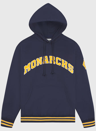 The Kansas City Monarchs 1924 Road Jersey Pullover Hoodie by Ebbets Field features “MONARCHS” in yellow on navy, a yellow patch on the left sleeve, front pocket, and striped rib cuffs and hem.