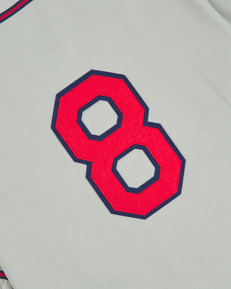 A gray Kansas City Monarchs 1936 Road Jersey Cotton Twill baseball jersey featuring a red number eight with a navy blue border.