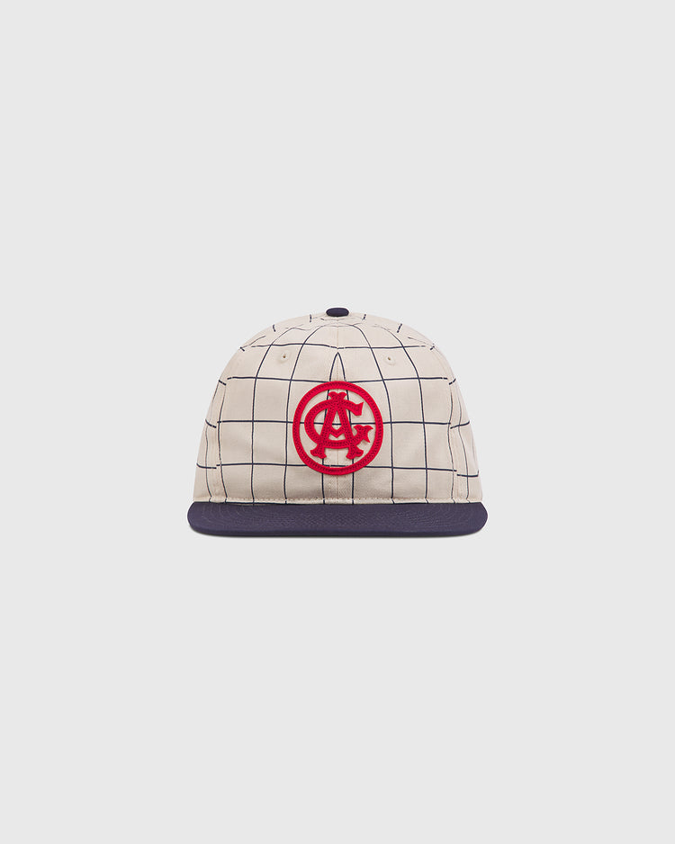 The Chicago American Giants 1919 Cotton Twill Ballcap by Ebbets Field features a beige crown, navy brim, black grid pattern, and bold red embroidered logo on the front, shown against a plain white background.