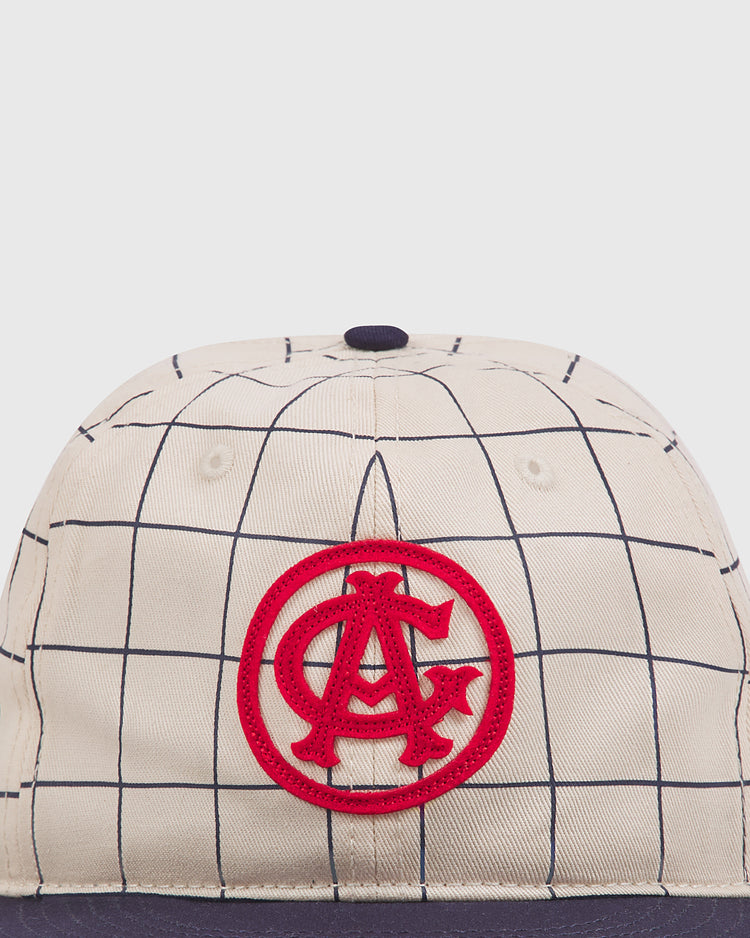 The Chicago American Giants 1919 Cotton Twill Ballcap by Ebbets Field features beige cotton twill, a navy grid pattern, a prominent red A/C logo on the front, and a navy blue brim.