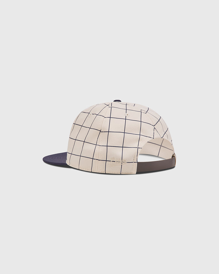 The Chicago American Giants 1919 Cotton Twill Ballcap by Ebbets Field features a beige crown, navy blue brim, grid pattern, and an adjustable strap. Displayed on a plain white background.