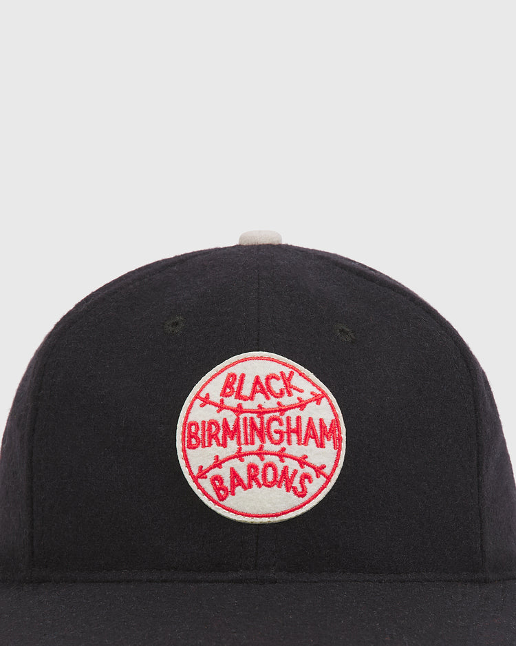 Ebbets Field Birmingham Black Barons 1924 Logo Wool Ballcap in dark navy, featuring a circular patch with a baseball design and red embroidered text.