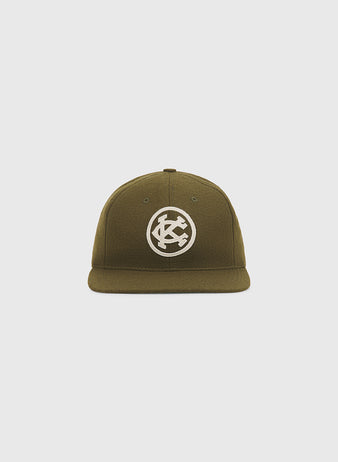 Olive green Ebbets Field Kansas City Monarchs 1924 Authentic Wool Ballcap with a flat brim and a circular white embroidered logo featuring the letters KC.