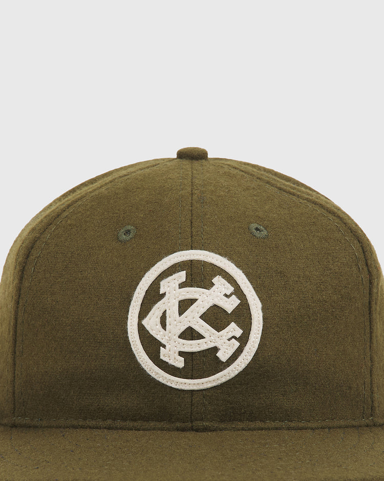 Olive green wool Kansas City Monarchs 1924 Authentic Wool Ballcap by Ebbets Field featuring a white circular patch with interlocking KC letters.