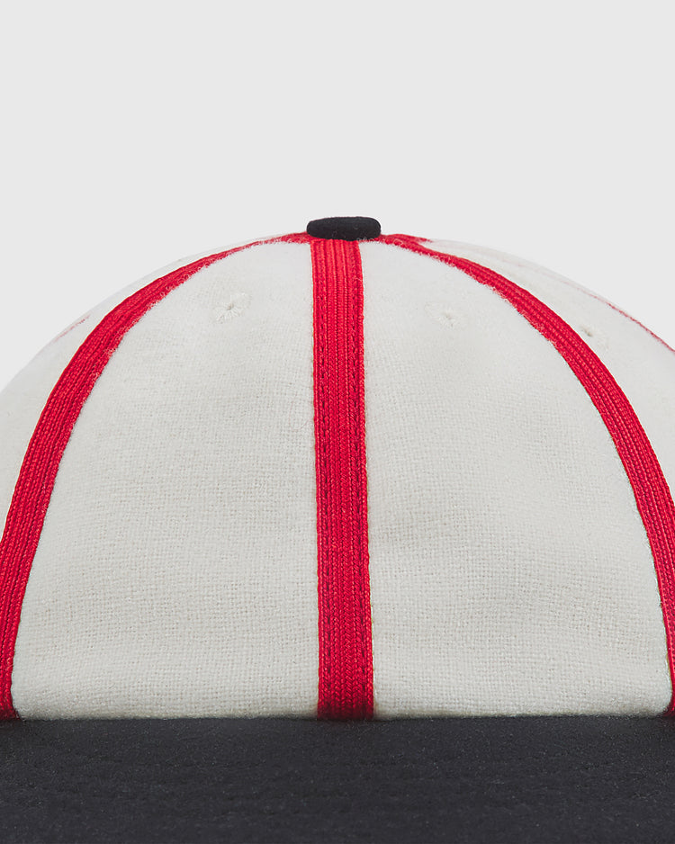 Close-up of an Ebbets Field Chicago American Giants 1920 8-Panel Short Brim Wool Ballcap, featuring a white eight-panel wool crown with red piping, a black top button, and a short black brim.
