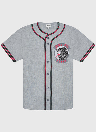 Channel classic baseball style with the Ebbets Field Tokio Senators 1936 Authentic Wool Road Jersey. This vintage gray wool jersey features black buttons, maroon and black striped detailing on the cuffs and collar, and a chest patch showcasing a stylized Native American chief alongside red “Senators World” lettering. Inspired by the original 1936 road uniforms of the Tokio Senators, this piece captures timeless baseball heritage.