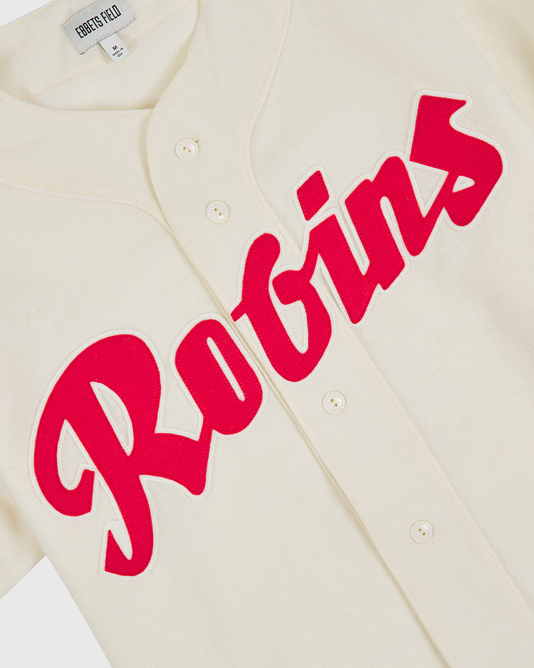 The Shochiku Robins 1950 Authentic Wool Home Jersey by Ebbets Field features a cream-colored wool design with “Robins” in bold red script across the front, faithfully inspired by the classic 1950 Japanese baseball jersey. The collar tag displays the Ebbets Field brand name.