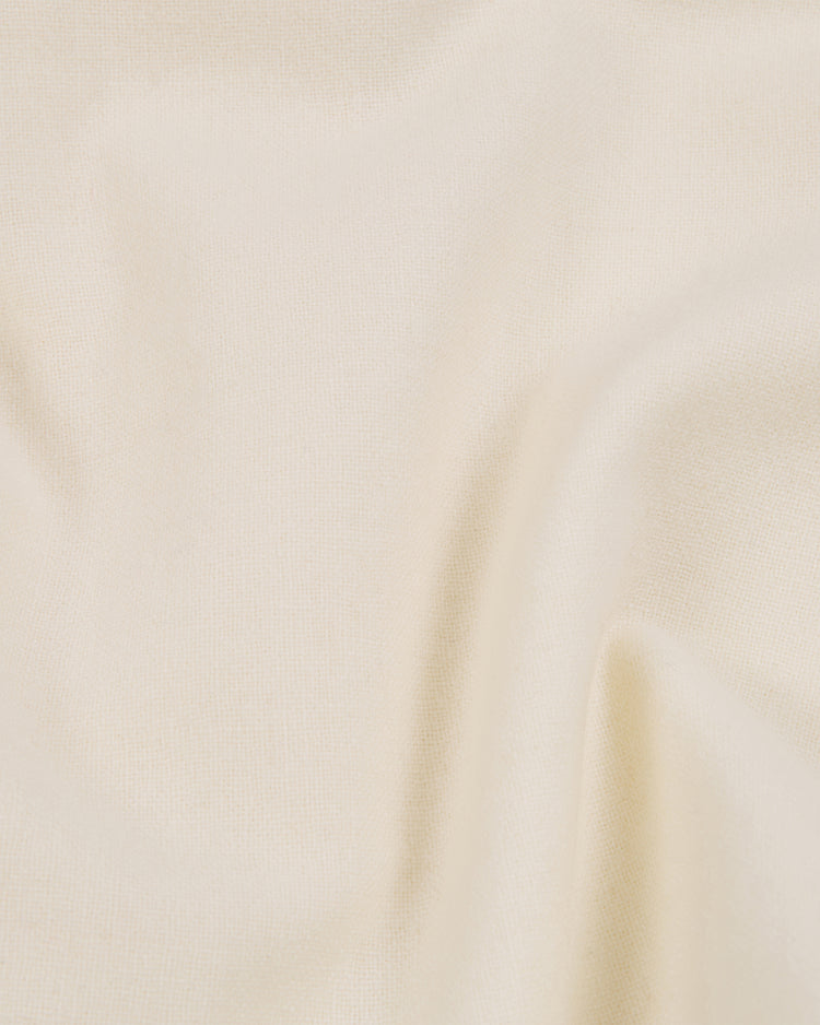 A close-up of a soft, cream-colored fabric with smooth, gentle folds and a subtly textured surface, reminiscent of the Ebbets Field Shochiku Robins 1950 Authentic Wool Home Jersey.