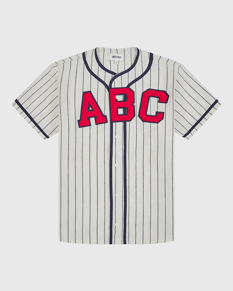 The Atlanta Black Crackers 1940 Authentic Home Jersey by Ebbets Field is a short-sleeve, white baseball jersey featuring thin black vertical stripes, a button-up front, a black-trimmed collar, and bold red “ABC” lettering across the chest.