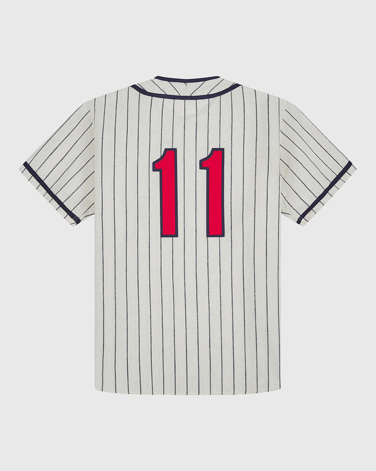 An Atlanta Black Crackers 1940 Authentic Home Jersey by Ebbets Field, featuring short sleeves, white fabric with dark blue vertical pinstripes, and a bold red number 11 on the back.