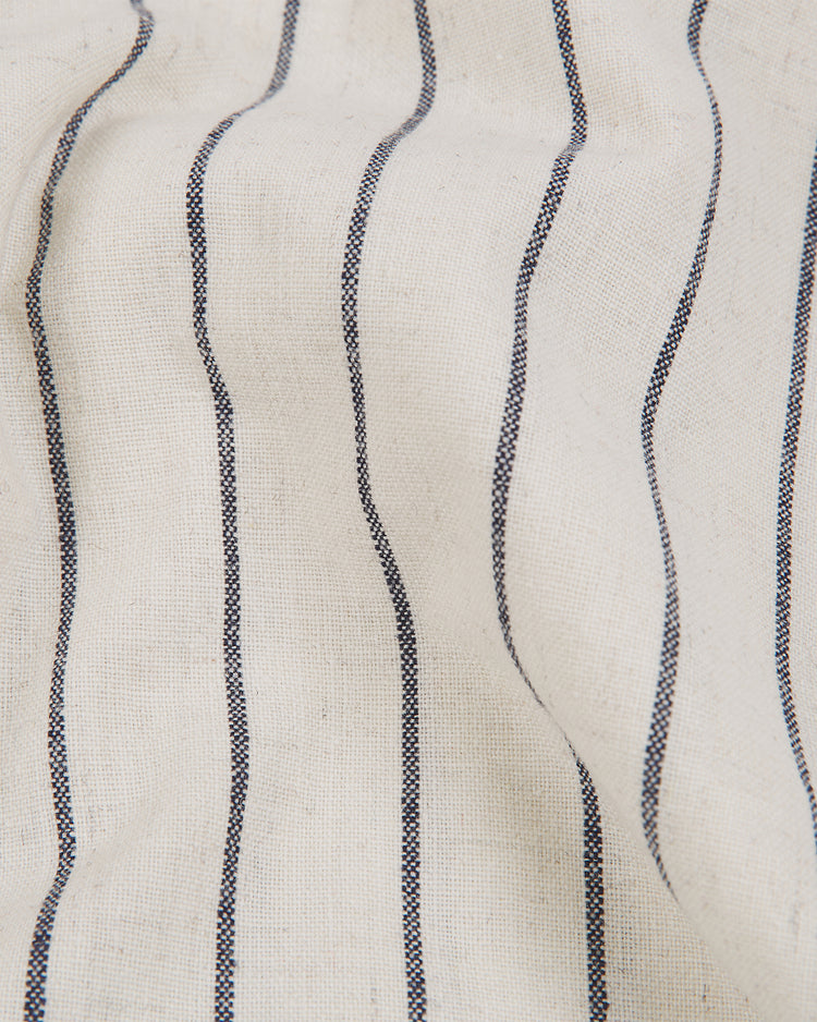 A close-up of the Ebbets Field Atlanta Black Crackers 1940 Authentic Home Jersey, highlighting its white fabric with evenly spaced vertical black stripes and a slightly wrinkled texture.