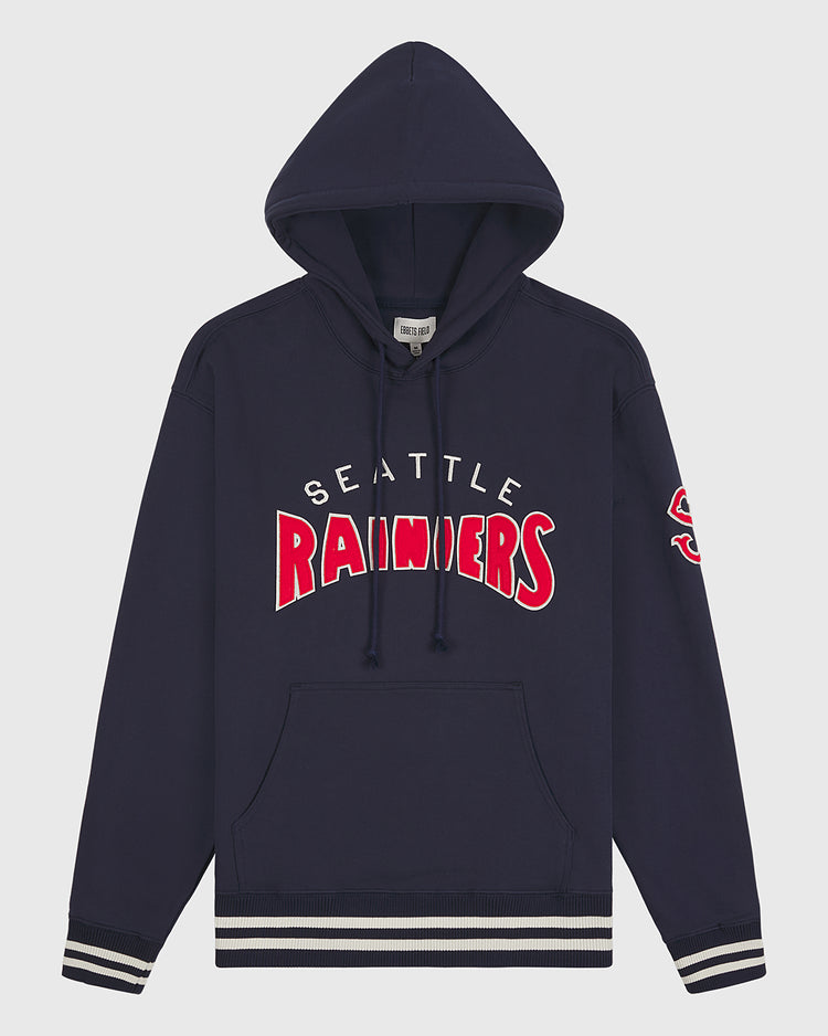 Seattle Rainiers 1941 Heavyweight Cotton Terry Pullover Hoodie by Ebbets Field. This navy blue pullover features “Seattle Rainiers” in bold white and red lettering across the front and a red S on the left sleeve. Detailed with classic white and navy striped cuffs and waistband for an authentic vintage baseball hoodie look.