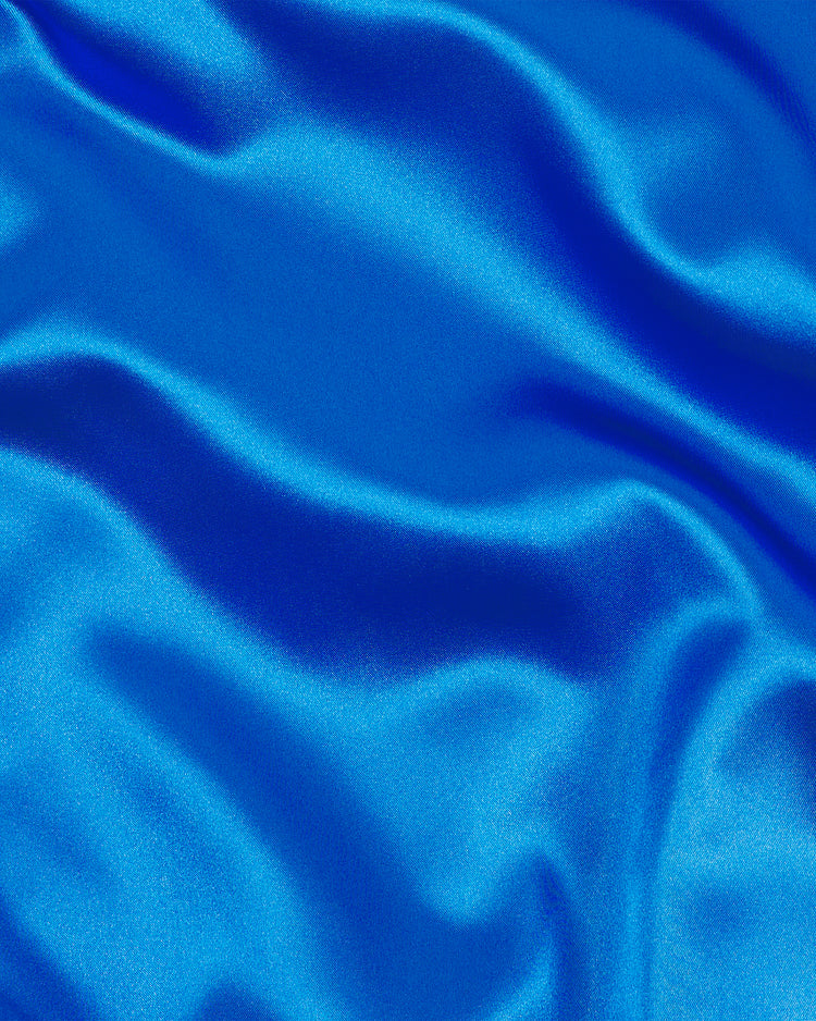 EFF’s Brooklyn Dodgers 1947-50 Authentic All Satin Varsity Jacket features bright blue satin fabric with soft, flowing folds and a shiny, smooth surface that evokes the iconic style of the legendary jacket worn by Jackie Robinson. The luxurious material captures the spirit of timeless movement and classic Dodgers heritage.