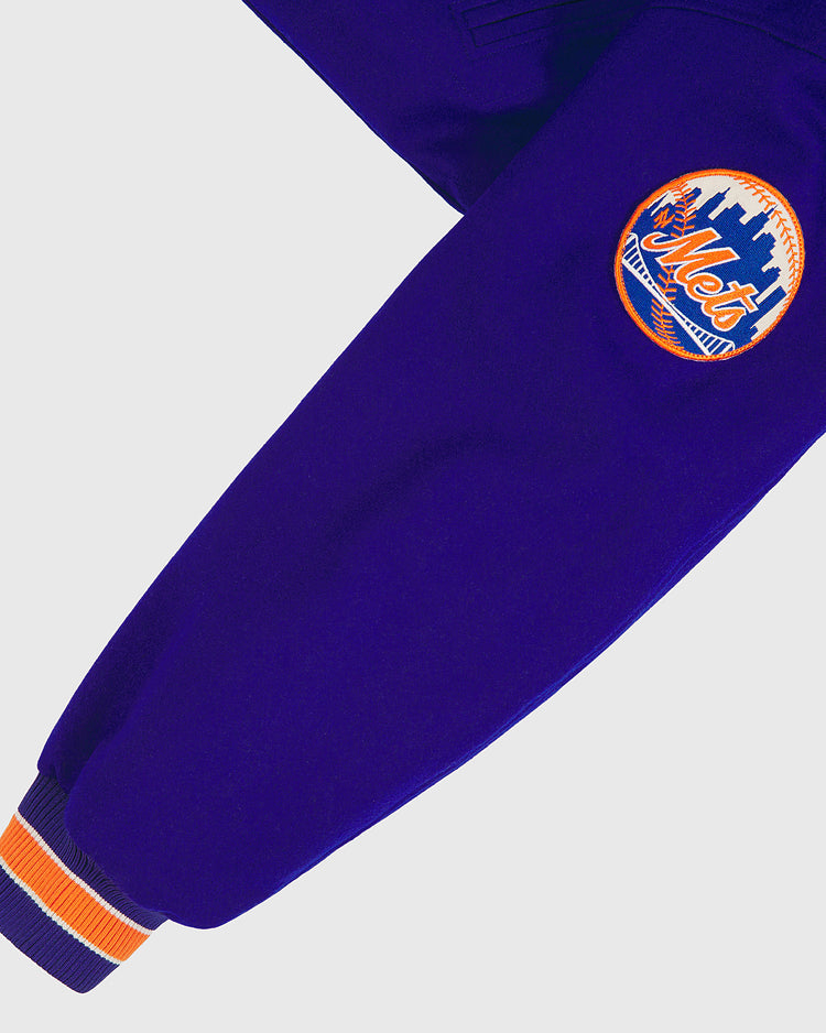 A close-up of a purple sleeve featuring an orange, blue, and white New York Mets patch and a striped orange, white, and blue cuff, from the EFF New York Mets 1969 Authentic All Wool Varsity Jacket—a faithful reproduction of the style worn by the Miracle Mets.