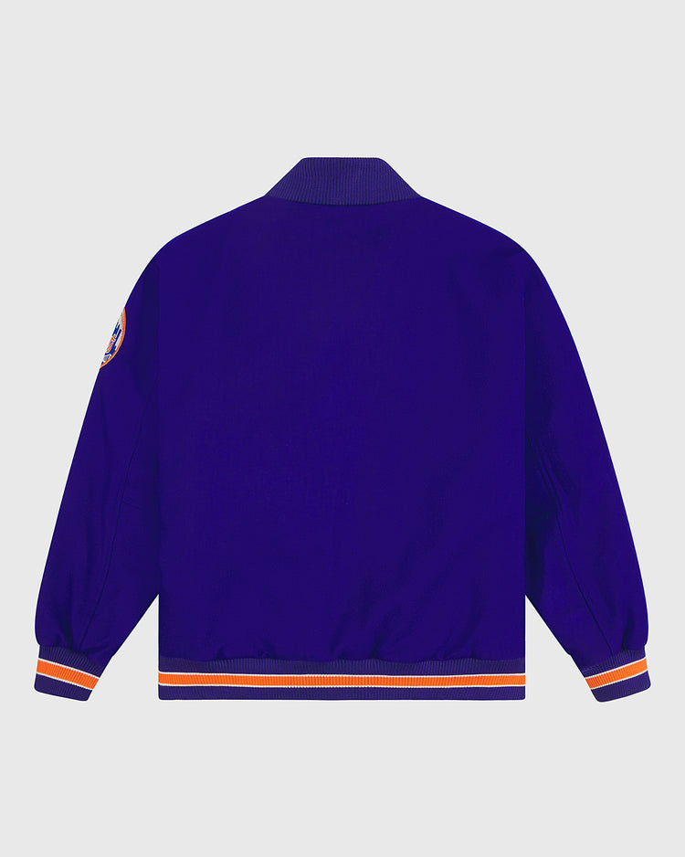 An authentic reproduction of the 1969 New York Mets jacket by EFF, the New York Mets 1969 Authentic All Wool Varsity Jacket is shown in royal blue from the back. It features orange and white striped cuffs and waistband, a collar, and a patch on the upper left sleeve, capturing the spirit of the Miracle Mets.