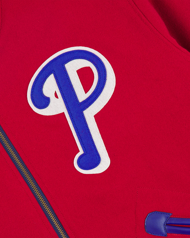 A close-up of the EFF Philadelphia Phillies 1949 Authentic All Wool Varsity Jacket showcases a prominent blue and white letter “P” patch and part of its gold zipper.