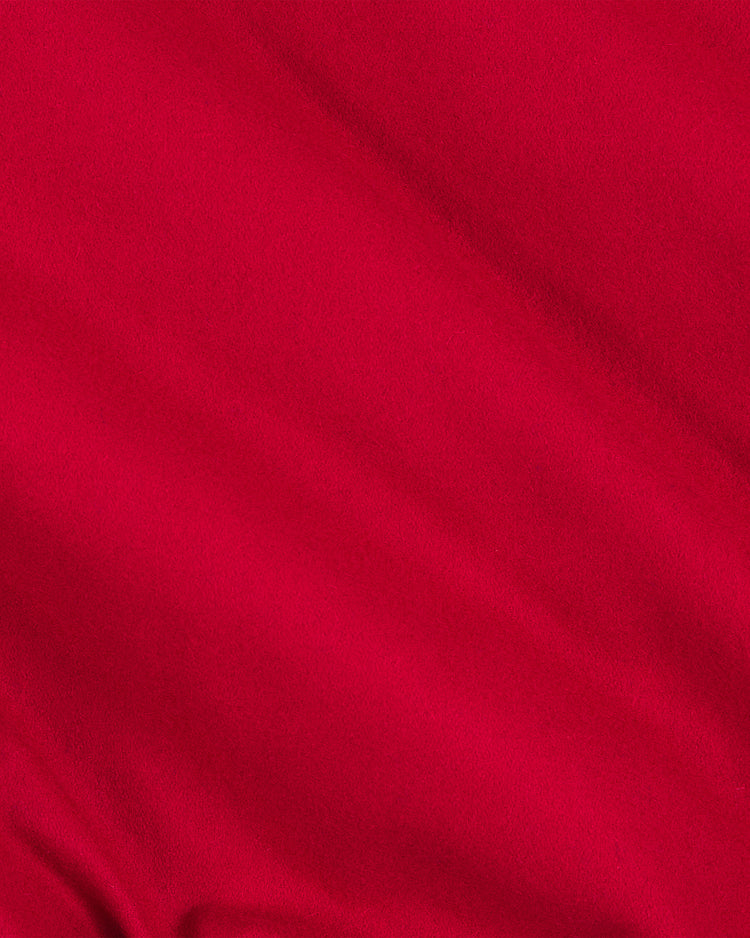 A close-up of a smooth, bright red all-wool fabric with gentle folds and soft texture, showing light and shadow variations—reminiscent of the material found on the EFF Philadelphia Phillies 1949 Authentic All Wool Varsity Jacket.