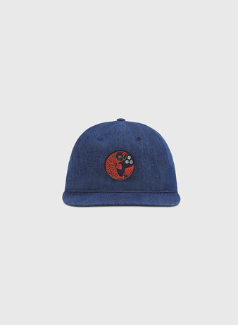 The Ebbets Field Hiroshima Carp Indigo Cotton Denim Twill Ballcap is shown against a plain light gray background, featuring a round red and black embroidered patch on the front with a stylized koi fish design—a subtle nod to Japanese baseball teams like the Hiroshima Carp.