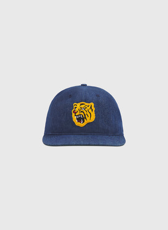 The Ebbets Field Osaka Tigers Indigo Cotton Denim Ballcap, displayed against a plain light gray background, features a yellow and black embroidered roaring tiger face on the front—capturing the fierce spirit of Koshien Field and drawing inspiration from the iconic Osaka Tigers.