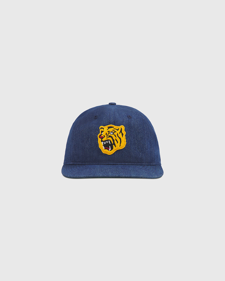 The Ebbets Field Osaka Tigers Indigo Cotton Denim Ballcap, displayed against a plain light gray background, features a yellow and black embroidered roaring tiger face on the front—capturing the fierce spirit of Koshien Field and drawing inspiration from the iconic Osaka Tigers.