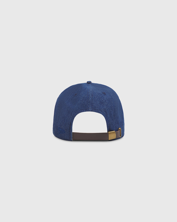A back view of the Ebbets Field Osaka Tigers Indigo Cotton Denim Ballcap, featuring an adjustable strap and metal buckle, displayed against a plain light grey background.