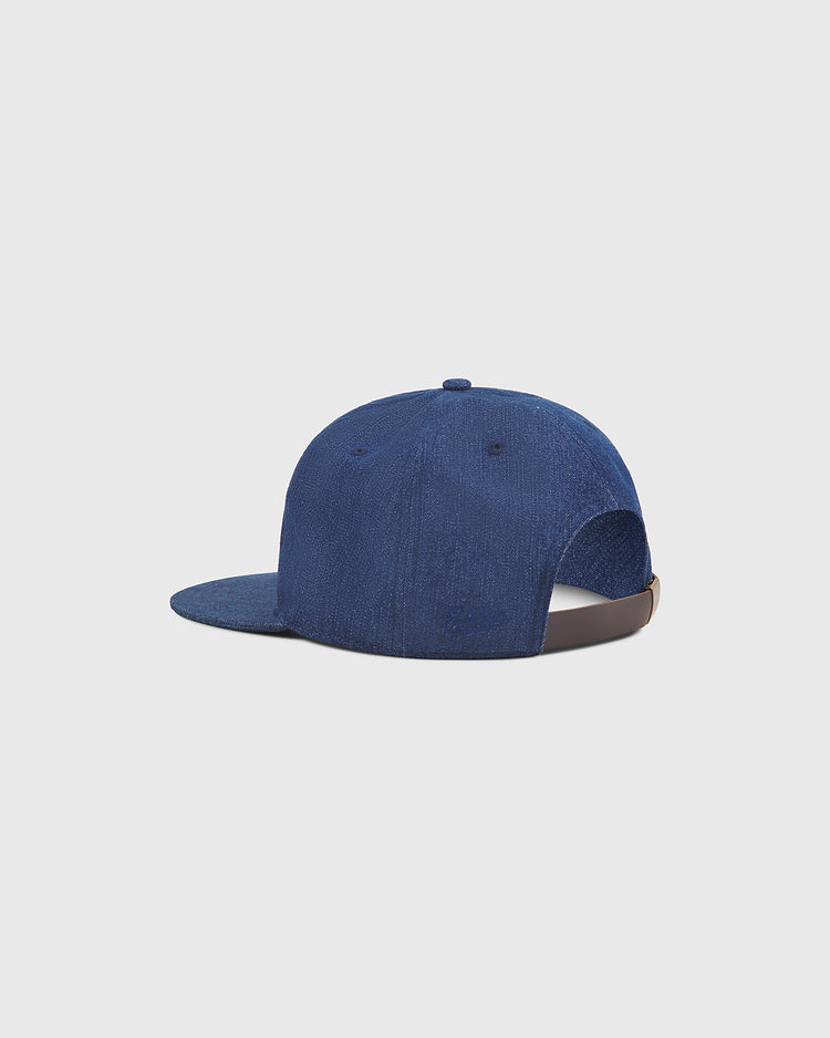 The Ebbets Field Osaka Tigers Indigo Cotton Denim Ballcap is displayed from the back against a plain light background, highlighting its adjustable strap and slightly curved brim—echoing the classic style worn at Koshien Field.
